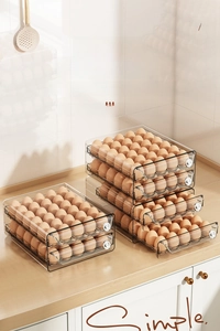 Macro detail of clear drawer-style egg storage box showing stackable double-layer design