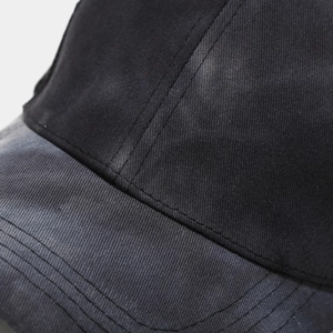 Close-up of black cotton twill baseball cap with reinforced multi-row stitching detail