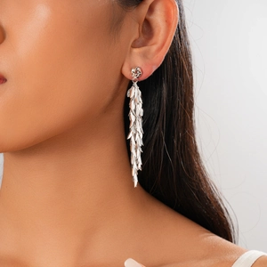 Macro detail of silver wheat leaf tassel earrings on model with elegant fringe effect