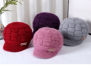 Detailed close-up of thick winter knit hats with metal bow accents in various colors