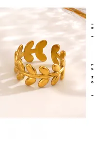 Macro detail of golden olive leaf ring showing textured surface and adjustable open design