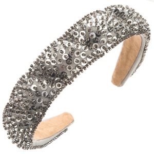 Close-up of a padded headband with silver sequins and hand-sewn dark grey beads