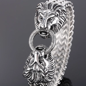 Detailed macro shot of a stainless steel lion head bracelet with intricate scale texture