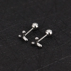 Detailed macro view of silver 16G stainless steel stud with screw-on ball back design