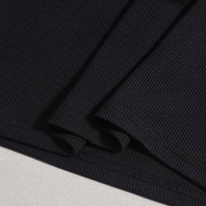 Macro shot of fine black ribbed knit fabric texture on a square neck bodycon dress