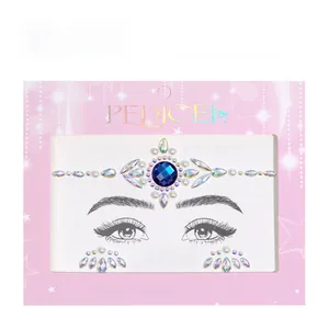 Detailed view of face body jewels with a blue central gem and iridescent rhinestones