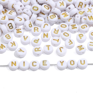 Detailed view of white acrylic letter beads with gold initials spelling NICE YOU on wire