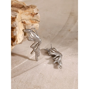 Macro shot of liquid metal style butterfly studs on a natural stone background
