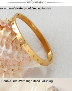 Detail of waterproof gold plated zircon bracelet leaning on a decorative conch shell