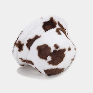 Close-up of thick cow print faux fur bucket hat with soft plush texture in brown and white