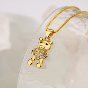Macro shot of gold heart-shaped bear pendant with micro-paved cubic zirconia