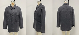 Detail view of washed denim jacket featuring large chest pockets and button-down front
