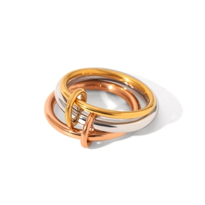 Macro shot of interlocking tri-color stainless steel rings in gold, silver, and rose gold