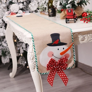Christmas burlap table runner with snowman applique and red bow for festive dining decor
