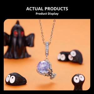 Detailed view of purple faceted crystal pendant held by silver dragon claws with zircon accents