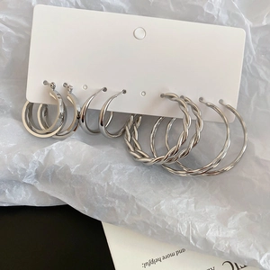 Detailed set of four silver hoop earrings featuring twisted, double layer and minimalist designs