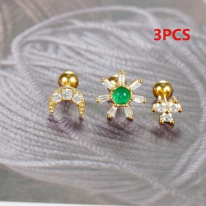 Macro shot of 3pcs gold ear studs set featuring moon and floral shapes with green gems