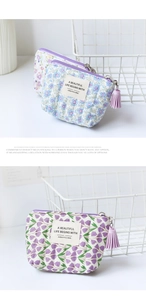 Detail of floral quilted coin purses with zipper tassels and elegant fabric labels