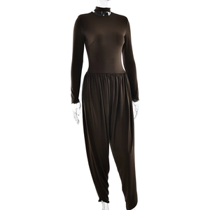 Detailed view of brown long sleeve jumpsuit with backless design and side slit details