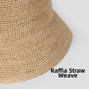 Close-up of hand-woven raffia braid texture on the brim of a stylish summer sun bucket hat