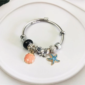 Silver shell and starfish charm bracelet with crystal beads and pink shell pendants