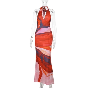 Detail showing deep V-neck and vibrant abstract print texture on floor-length dress