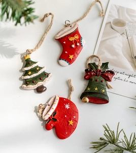 Detailed flat lay of resin Christmas ornaments featuring a tree, bell, sock, and glove