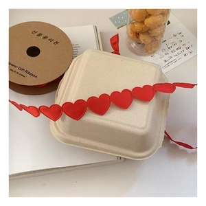Detail of red heart satin ribbon on paper spool for floral and gift cake packaging