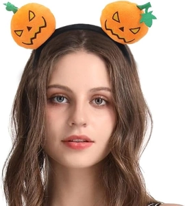 Close-up of a plush Halloween pumpkin headband with spooky expressions on a model