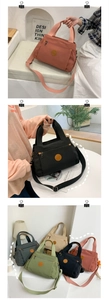 Detail of multi-compartment canvas handbags in various colors with adjustable shoulder straps