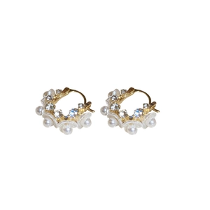 Elegant gold-tone hoop earrings featuring white faux pearl flowers and sparkling crystals