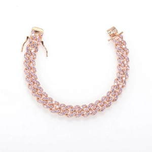 Macro view of rose gold Cuban link bracelet with sparkling pink and clear rhinestones