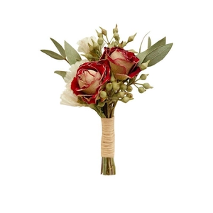 Elegant boutonniere featuring dark red roses and white flowers for wedding ceremonies