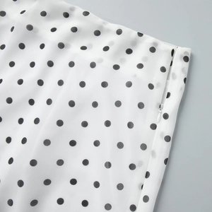 Detailed view of polka dot skirt featuring high-quality white invisible side zipper