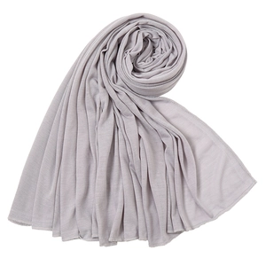 Close-up of light purple jersey wrap scarf showing elastic knit texture and fine overlock edge