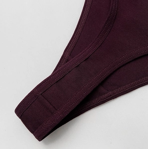 Detail of deep purple ribbed cotton thong showing precise double-stitched reinforced edges