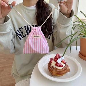 Detailed view of pink striped drawstring bag featuring Sozakka woven label and cotton ropes