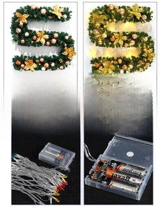 Détail de guirlande de Noël 2,7m verte avec boules dorées champagne et boîtier LED