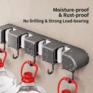 Suction cup wall mop holder with hooks showing strong weight-bearing capacity on wall