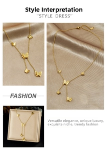 Detail of gold butterfly tassel necklace showing matte textures and layered chain design