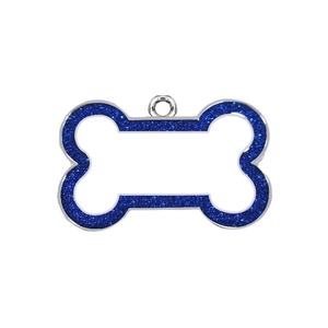 Detailed view of a bone-shaped pet ID tag with blue glitter and blank engraving space