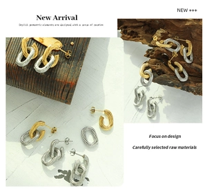 Detailed view of two-tone gold and silver link earrings with textured twisted metal finish