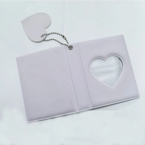 Detail of white 3-inch photo album with heart hollow design and metal heart pendant