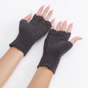 Close-up of dark grey fingerless knit gloves featuring ribbed cuffs and hollow patterns