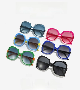 Detailed row of oversized butterfly sunglasses in assorted colors on white background