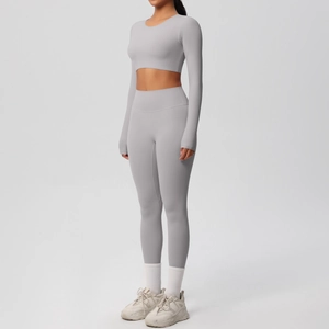 Detail view of high-stretch light grey yoga set with cropped long sleeve top and leggings