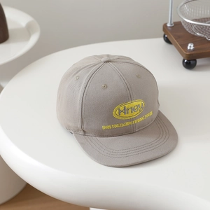 Detail of khaki cotton hip-hop flat brim cap with yellow embroidery and oval logo patch