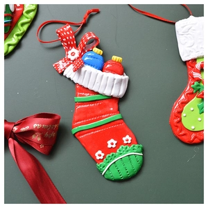 Detailed handmade Christmas stocking pendant with red polka dot bow and festive charms