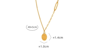 Detail of gold pendant necklace showing Good Luck engraving and cuban chain segments