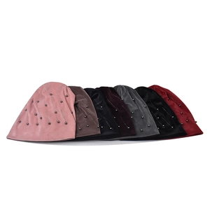 Detail of velvet chenille beanies with silver bead embellishments in various colors